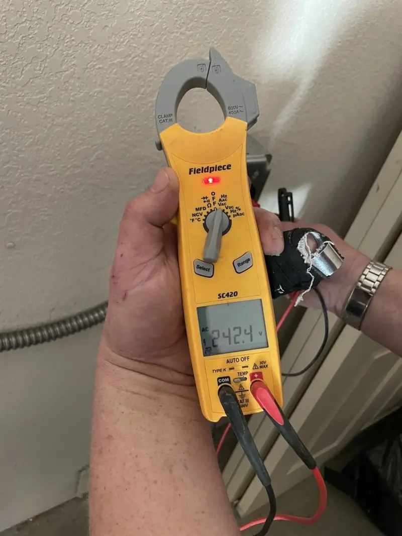Voltage testing with clamp meter during Electrical Installation Services in Decatur